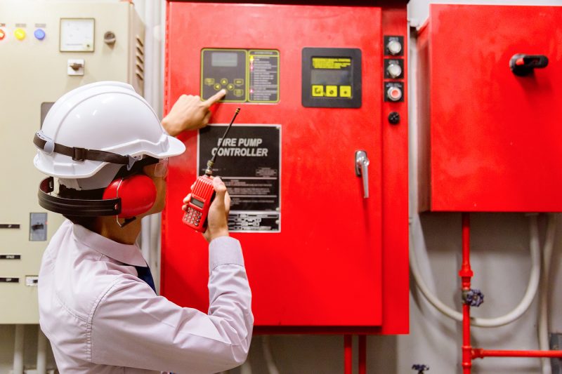 Engineer checking an industrial fire control system panel